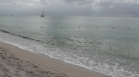 MEXICO-049 SMALL TRANQUIL WAVES AND SAILBOAT Stock Footage 10607727