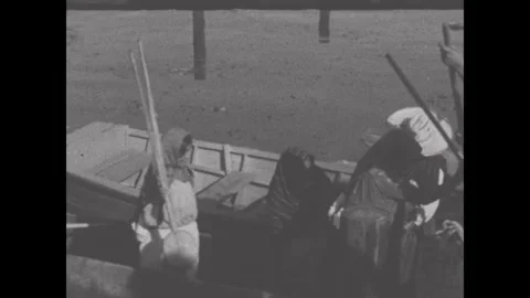 Mexico 1950s: Hands work over a fish on a wooden cutting board, cleaning and Stock Footage 340704104