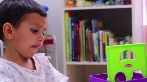 Mexico, 2014: BACK SHOULDER. Convalecient child playing with a nurse. Stock Footage 45820138