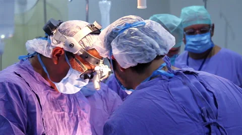 Mexico, 2014: CLOSE UP-BACK SHOULDER. Surgeons faces during surgery. Stock Footage 48211179