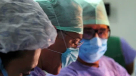Mexico, 2014: CLOSE UP. Faces surgeons during surgery. Stock Footage 48471791
