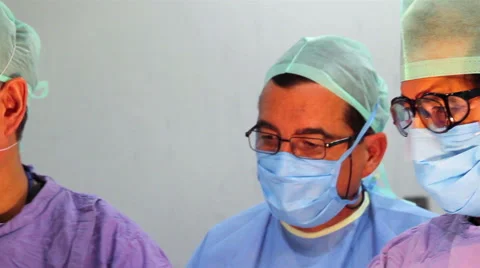 Mexico, 2014: CLOSE UP-PAN LEFT. Faces surgeons during surgery. Stock Footage 48471173