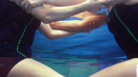 Mexico, 2014: FULL SHOT-HANDHELD SHOT. Woman doing rehab exercises inside a pool Stock Footage 45016342