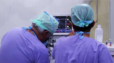 Mexico, 2014: MEDIUM SHOT. Doctors looking a monitor during surgery. Stock Footage 48202995