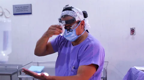 Mexico, 2014: MEDIUM SHOT. Surgeon testing a light before surgery. Stock-Footage 48208434