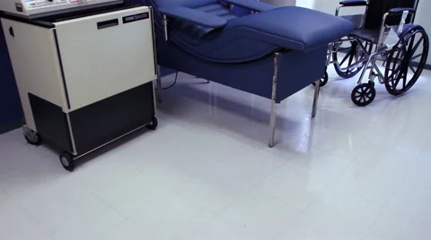 Mexico, 2014: TILT UP-FULL SHOT. Hospital gurney and a wheel chair. Stock Footage 44986178