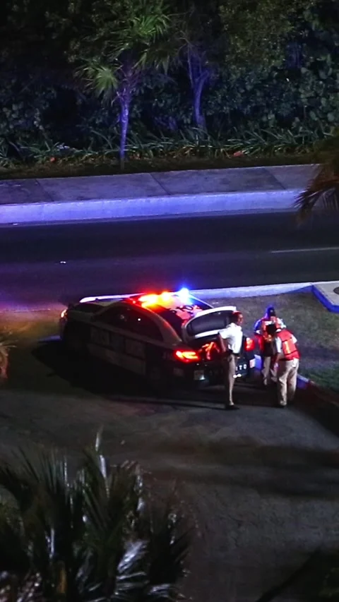 MEXICO, CANCUN - 11 MARCH 2015: Police officers near car at downtown. Night time Stock Footage 309594121