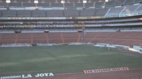 Mexico City - 1975: empty Azteca stadium tribune seats panorama and pitch Stock Footage 220643841