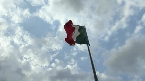 Mexico flag flying on flagpole on cloudy day. Horizontal shot Stock Footage 291578740