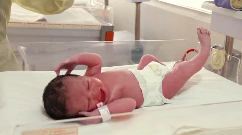 Mexico: FULL SHOT-HANDHELD SHOT. Newborn screaming in a cradle. Stock Footage 48933461