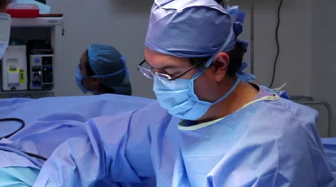 Mexico: FULL SHOT. Surgeons watching a monitor during a hand surgery. Stock Footage 48950108
