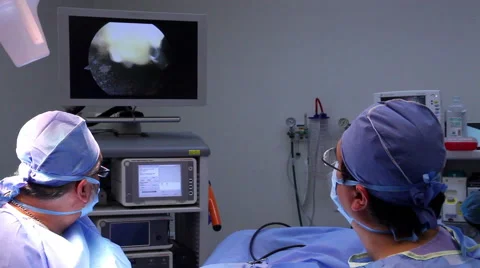 Mexico: FULL SHOT. Surgeons watching a monitor during a hand surgery. Stock Footage 48950351