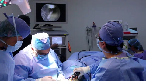 Mexico: FULL SHOT. Surgeons watching a monitor during a hand surgery. Stock Footage 48950809