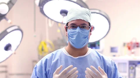 Mexico: MEDIUM SHOT-PAN RIGHT. Surgeon ready for surgery posing for the camera. Stock Footage 48946551
