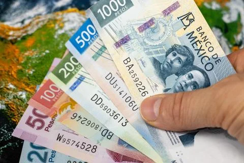 Mexico pesos against the background of the world, concept, financial Stock Photos