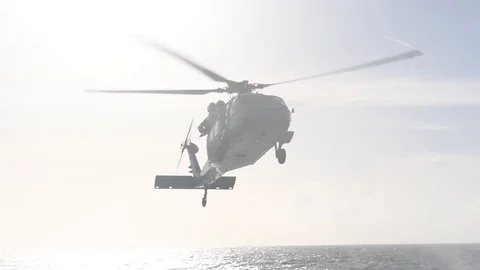 MH-60 Seahawk approaching USS Curtis Wilbur to land Stock Footage 104855712