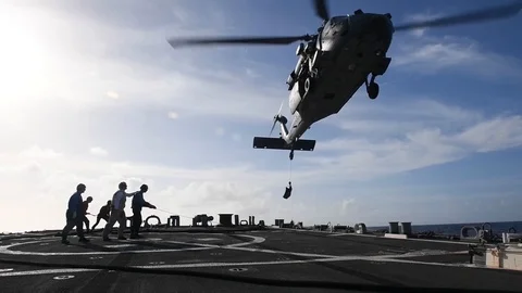 MH-60 Seahawk helicopter hovering above flight deck of USS Curtis Wilbur Stock Footage 104855709