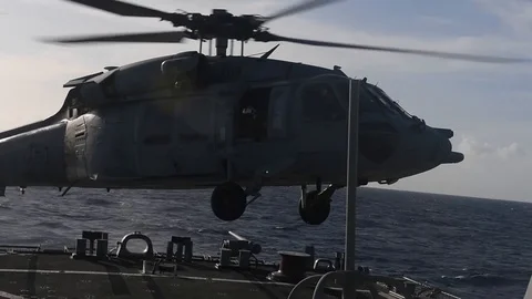 MH-60 Seahawk helicopter hovering above flight deck of USS Curtis Wilbur Stock Footage 104855745
