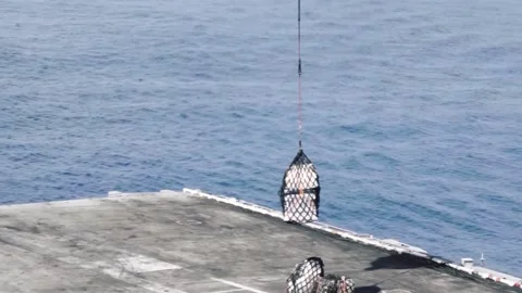 MH-60 Seahawk lifting cargo from deck of ship during replenishment at sea Видео 161794580