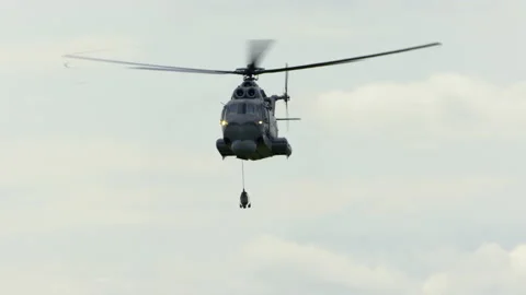 Mi-14PŁ helicopter doing maneuvers at air show in Gdynia Stock Footage 136498406