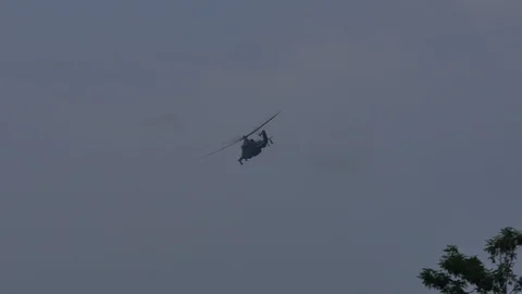 Mi-24 attack helicopter in a distance turns and fly left Stock Footage 123292155