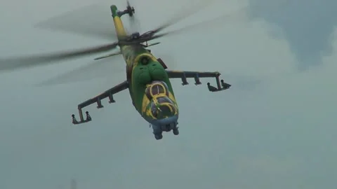 Mi-24 / Mi-35 helicopter (NATO: Hind) dive to low altitude to attack targets. Stock Footage 130645835