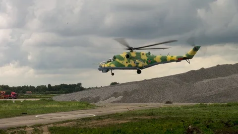 Mi-24 or Mi-35 helicopter (NATO: Hind) slowly descends vertically for landing. Stock Footage 123762402