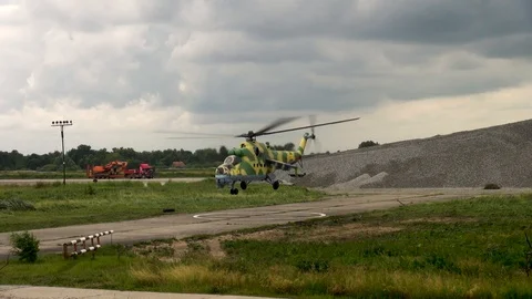 Mi-24 or Mi-35 helicopter (NATO: Hind) slowly descends vertically for landing. Stock Footage 123762422