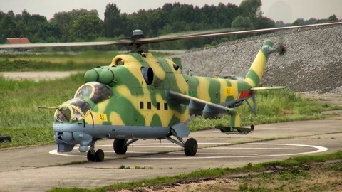 Mi-24 or Mi-35 helicopter (NATO: Hind) slowly descends vertically for landing. Stock Footage 123762448