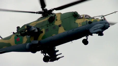 Mi-35 or Mi-24 military helicopter (NATO: Hind) performs slow U-turn. Stock Footage 123635301