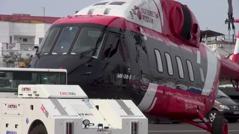 Mi-38-2 multipurpose transport helicopter is towed by tractor in parking lot. Stock Footage 148624785