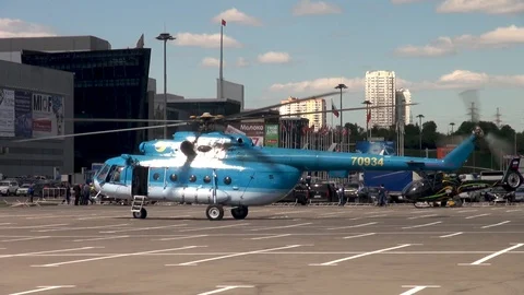 MI-8 helicopter with rotating blades against administrative buildings. Stock Footage 106799593
