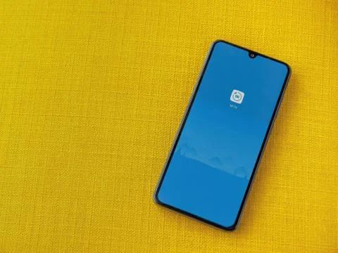 Mi Fit app launch screen with logo on the display of a black mobile smartphon Stock Photos