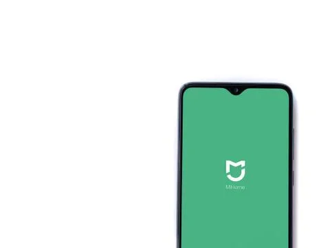 Mi Home app launch screen with logo on the display of a black mobile smartpho Stock Photos