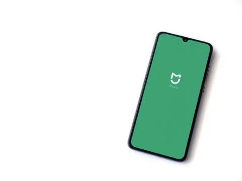 Mi Home app launch screen with logo on the display of a black mobile smartpho Stock Photos