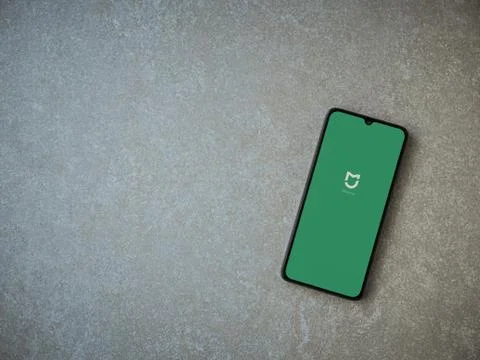 Mi Home app launch screen with logo on the display of a black mobile smartpho Stock Photos