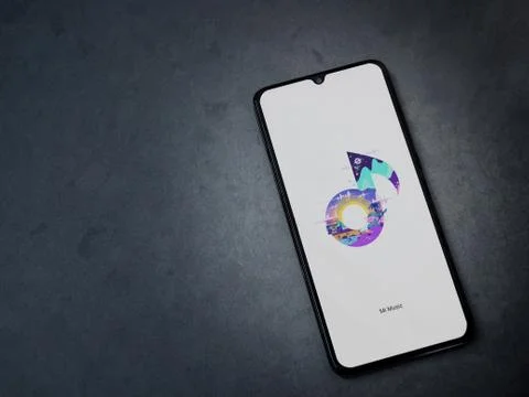 Mi Music app launch screen with logo on the display of a black mobile smartph Stock Photos