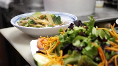 Mi Xào Pan Fried Egg Noodles and Fresh Salad Greens in Thai Restaurant Kitchen Stock Footage 348345480