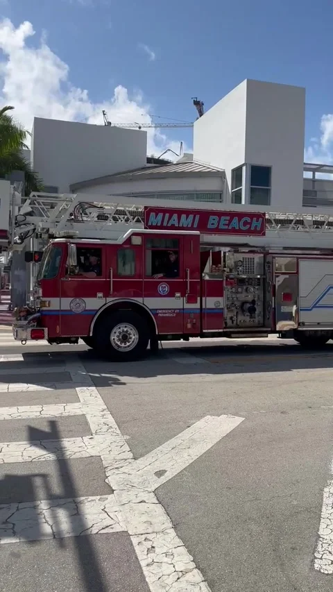 Miami Beach Fire Department fire truck crossing road on 5th street Stock Footage 243603356