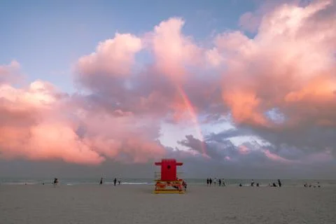 Miami Beach under the bright cloudy sky with  a rainbow in the center Stock Photos