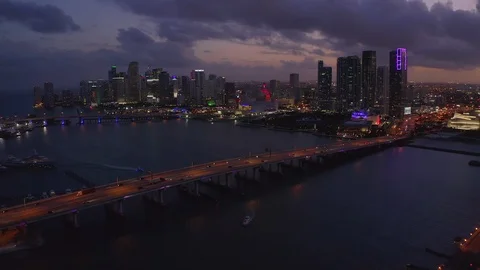 Miami downtown buildings bridge skyline aerial flying evening night sunset Stock Footage