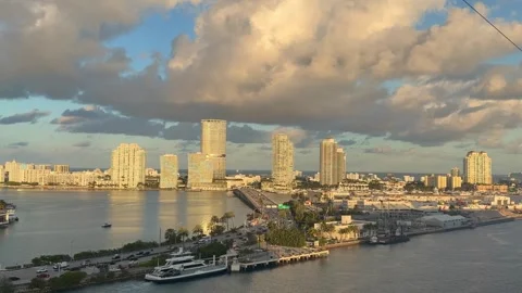 Miami Florida skyline with E Port Boulevard, buildings, and water at sunset 動画素材 329685804