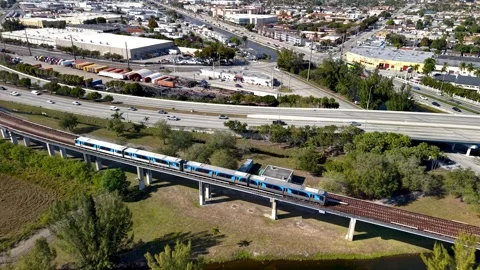 Miami metrorail train crossing a bridge over the Miami river aerial view. Video stock 333602439