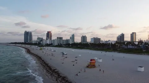 MIAMI-SOUTH BEACH- SUNSET-PULL &amp; PAN NORTH OVER OCEAN Stock Footage 247461101
