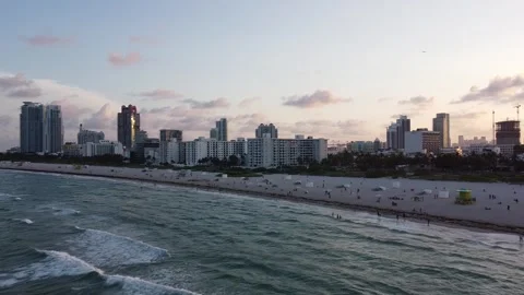 MIAMI-SOUTH BEACH-SUNSET-PUSH SOUTHWEST ACROSS WATER TO BEACH Stock Footage 247461216