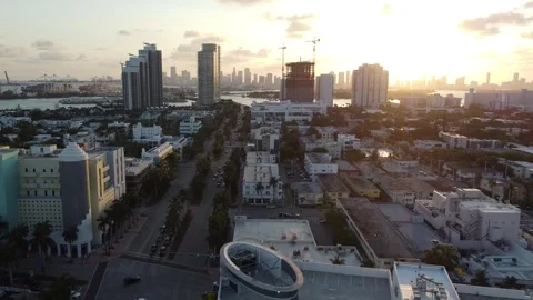 MIAMI-SUNSET-PULL FROM DOCKS ACROSS SOUTH BEACH-TILT DOWN TO WATER Stock Footage 247461252