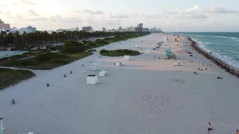 MIAMI-SUNSET SOUTH BEACH-PUSH NORTH - TILT DOWN ON COLLINS AVE Stock Footage 247461250