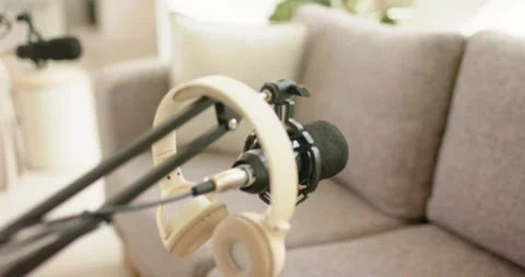 Mic and headset staying while camera pulling back teal arm adjusting boom Stock Footage 336609666
