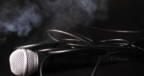 Mic drop representing music isolated on black smoke blowing Video stock 204062775