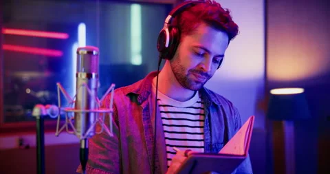 Mic, man and reading with notebook for broadcast, talk show and script for Stock-Footage 331984108